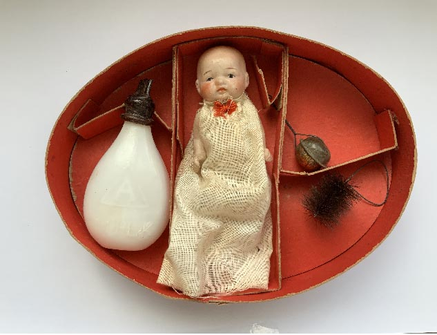 antique boxed Japanese dolls set including a bisque doll and glass bottle